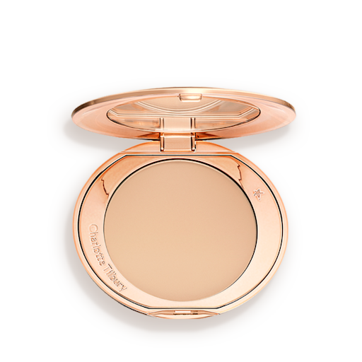 AFF-MEDIUM-LEGENDARY-PDP 1 An open, pressed powder compact in a light beige shade.
