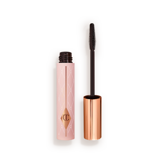 Mascara in a pink-coloured tube with its gold-coloured lid with a black applicator next to it. 