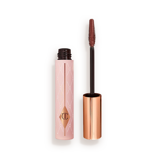 Pillow Talk Push up! Lashes Mascara Dream Pop open An open tube of a chocolate-brown-coloured mascara in a pink-coloured tube with a gold-coloured lid.